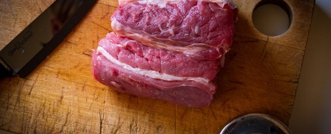 raw pet food on wood cutting board